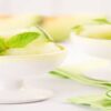 Honeydew-Melon-Sorbet-A-Refreshing-Healthful-Dessert-featured-image-200x600w-2-white-dishes-with-scoops-of-honeydew-sorbet-with-halves-of-honeydew-melon-in-the-background-frosted-fusions