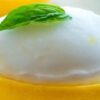 Luscious-Lemon-Sorbet-Zesty-Citrus-Bliss-featured-632x2000w-jpeg-lemon-sorbet-in-lemon-shell-with-basil-leaf-on-top-frosted-fusions
