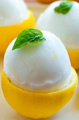 Luscious Lemon Sorbet Zesty Citrus Bliss image 5 jpeg Half lemon with scoop of lemon sorbet plus basil leaf frosted fusions