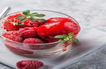 Berrylicious-Homemade-Raspberry-Sorbet-featured-image-200x600w-raspberry-sorbet-in-glass-dish-with-fresh-raspberries-and-sprigs-of-green-leaves-frosted-fusions