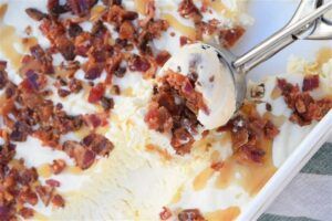 Savoury-Sweet-Extreme-Bacon-Maple-Syrup-Homemade-Ice-Cream-image-4-vanilla-ice-cream-with-crumbled-pieces-of-bacon-and-maple-syrup-drizzled-frosted-fusions