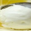 Zesty-citrusy-homemade-lemon-gelato-featured-image-832x2550w-tray-of-lemon-gelato-being-scooped-with-slices-of-lemon-frosted-fusions