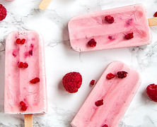 Berrylicious Homemade Raspberry Sorbet image 6 raspberry sorbet ice lollies with fresh raspberries on marble background frosted fusions