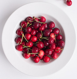 cherry-bakewell-bliss-a-delectably-classic-cherry-bakewell-homemade-ice-cream-image-2-jpeg-white-plate-filled-with-bright-red-cherries-white-background-frosted-fusions