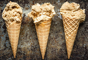 salivate-over-the-irresistible-charm-of-salted-caramel-ice-cream-image-3-jpeg-3-salted-caramel-ice-creams-in-cones-lined-up-dark-background-frosted-fusions