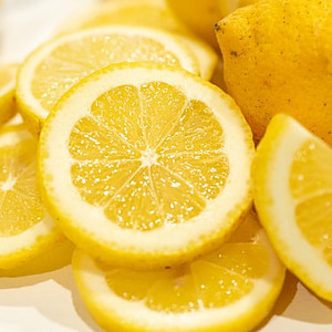 Zesty Citrusy Homemade Lemon Gelato Image 1 jpeg pile of sliced lemon + whole lemon frosted fusions