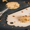 Creamy-Nutty-Perfection-An-Irresistible-Homemade-Peanut-Butter-Ice-Cream-featured-image-200x600w-jpeg-peanut-butter-ice-cream-on-board-with-nuts-scattered-and-scoop-frosted-fusions