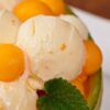 Deliciously-Refreshing-Homemade-Apricot-and-Thyme-Ice-Cream-Recipe-featured-image-200x600w-jpeg-apricot-ice-cream-with-balls-of-fresh-apricot-and-green-leaves-frosted-fusions