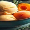 Homemade-Apricot-and-Thyme-Ice-Cream-Recipe-updated-feb25-featured-image-637x1920w-bowl-of-apricot-ice-cream-with-fresh-apricots-and-thyme-Frosted-Fusions