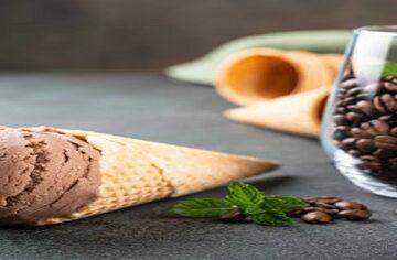 The-Perfect-Brew-Homemade-Coffee-Ice-Cream-featured-image-200x598w-coffee-ice-cream-in-a-cone-plus-glass-filled-with-coffee-beans-and-some-fresh-leaves-frosted-fusions