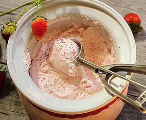 Mastering Homemade Ice Cream Using Ice Cream Makers Techniques and Tips image 3 strawberry ice cream in ice cream maker freeze bowl with scattered strawberries frosted fusions