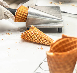 Mastering the Art Make Homemade Ice Cream Cones image 2 ice cream cones being rolled with cone shaper frosted fusions