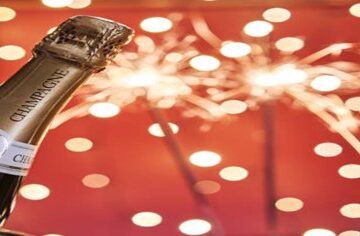 Homemade-Champagne-and-Raspberry-Ice-Cream-Cheers-to-the-New-Year-featured-image-200x600w-bottle-of-champagne-with-sparklers-in-the-background-frosted-fusions