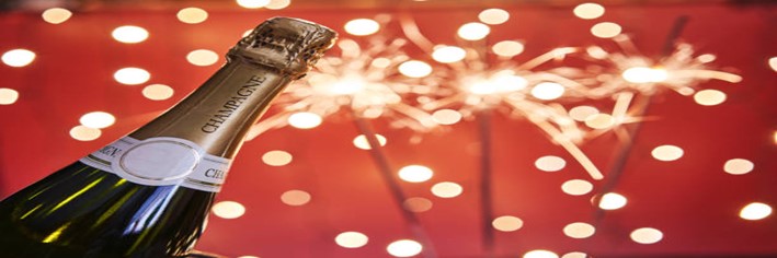 Homemade-Champagne-and-Raspberry-Ice-Cream-Cheers-to-the-New-Year-featured-image-200x600w-bottle-of-champagne-with-sparklers-in-the-background-frosted-fusions