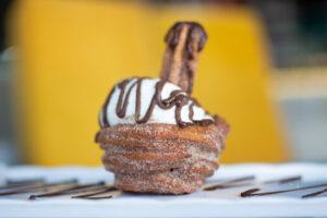 Kid-Friendly-Christmas-Ice-Cream-Recipes-image-10-ice-cream-in-churros-bowl-drizzled-with-chocolate-sauce-frosted-fusions