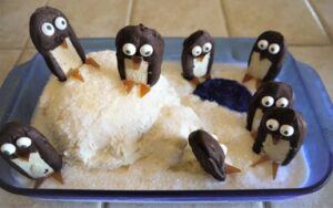Kid-Friendly-Christmas-Ice-Cream-Recipes-image-12-icecream-and-chocolate-penguins-on-tray-with-vanilla-snow-frosted-fusions