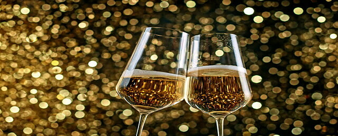 Homemade Champagne and Raspberry Ice Cream Cheers to the New Year image 1 two champagne flutes chinking with gold glitter in background frosted fusions