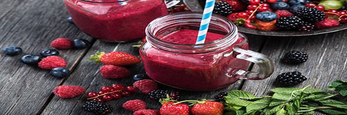 A-Delicious-And-Nutrient-Packed-Berry-Blast-Smoothie-featured-image-200x600w-reddish-pink-smoothies-glass-jars-several-types-of-berries-scattered-fresh-green-leaves-frosted-fusions