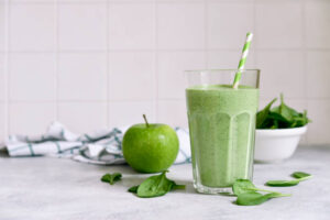 New-Year-Fresh-Vibes-Nourish-Your-Body-With-Healthful-Smoothies-updated-jan25-image-1-Green-smoothie-with-some-green-ingredients-scattered-frosted-fusions