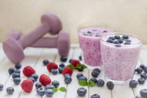 New-Year-Fresh-Vibes-Nourish-Your-Body-With-Healthful-Smoothies-updated-jan25-image-5-mixed-berry-protein-smoothies-with-dumbells-in-the-background-frosted-fusions