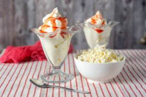 New-Year-New-You-Discover-Guilt-Free-Homemade-Ice-Cream-to-Indulge-updated-2025-image-2-two-glass-dishes-with-ice-cream-and-strawberry-sauce-dish-of-cottage-cheese-to-the-side-frosted-fusions