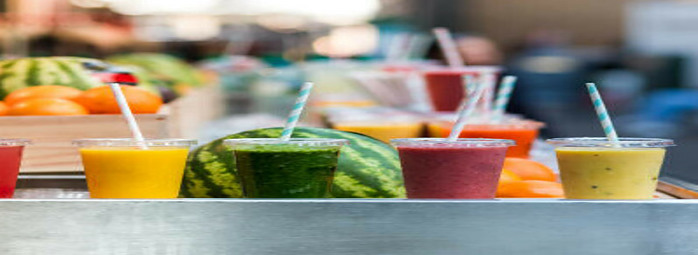 New Year, Fresh Vibes: Nourish Your Body With Healthful Smoothies image 1 6 smoothies lined up all different colours and mixtures with fresh fruit in the background frosted fusions