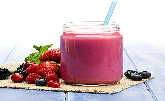 New Year, Fresh Vibes: Nourish Your Body With Healthful Smoothies image 4 pink smoothies in glass jar with straw with fresh berries scattered frosted fusions