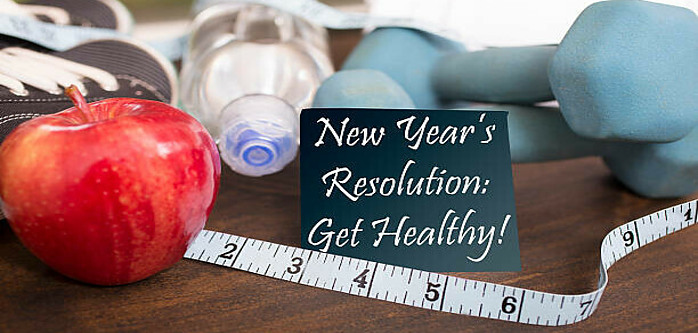 New Year New You Discover Guilt-Free Homemade Ice Cream to Indulge image 1 sign saying new years resolution get healthy with apple tape measure dumbells trainers and water frosted fusions