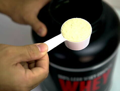 Protein Shake Fusions Creating Protein Rich, Low-Fat, Homemade Ice Cream image 1 scoop of protein powder with whey protein bottle in background frosted fusions