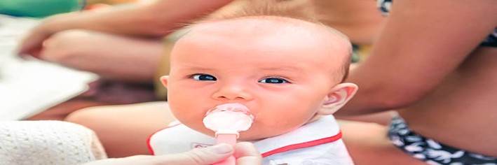 Can-I-Give-My-Baby-Ice-Cream-featured-image-200x600w-young-baby-being-given-a-spoon-of-ice-cream-frosted-fusions