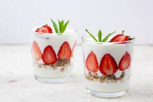 Love-In-Layers-Homemade-Strawberries-And-Cream-Parfait-image-8-two-glasses-of-strawberry-parfait-with-fruit-patterns-frosted-fusions
