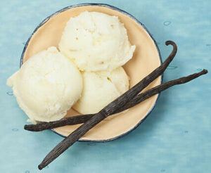 sweet-treats-for-mum-homemade-ice-cream-to-celebrate-mother-day dish of ice cream with vanilla pods blue background Frosted Fusions