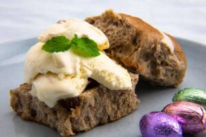 Easter-Treats-Reinvented-Hot-Cross-Buns-And-Homemade-Ice-Cream-image-7-hot-cross-bun-with-ice-cream-oozing-and-sprig-of-fresh-leaves-frosted-fusions