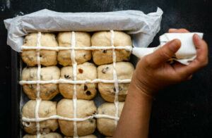 easter-treats-reinvented-hot-cross-buns-and-homemade-ice-cream-image-2-hot-cross-buns-being-iced-with-cross-prior-to-oven-baking-frosted-fusions