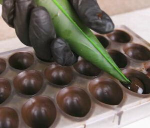 homemade-cadbury-egg-ice-cream-recipe-image-6-egg-moulds-being-filled-with-chocolate-frosted-fusions