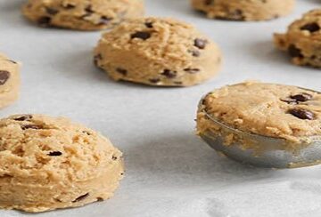 Easy-Homemade-Cookie-Dough-Ice-Cream-Recipe-update-dec24-featured-image-207x620w-cropped-blobs-of-cookie-dough-being-scooped-on-parchmant-paper-for-baking-frosted-fusions
