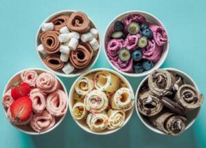 From-Scoop-To-Roll-Learn-To-Create-Your-Own-Homemade-Ice-Cream-Rolls-image-11-pots-of-various-different-flavoured-ice-cream-rolls-with-fresh-fruit-and-choc-chip-toppings-frosted-fusions