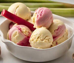 Homemade-Rhubarb-And-Custard-Ice-Cream-Recipe-image-5-white-bowl-of-rhubarb-and-custard-ice-cream-with-stalk-of-rhubarb-in-ice-cream-and-rhubarb-in-background-frosted-fusions