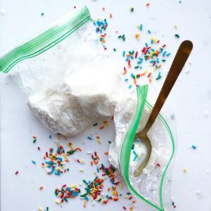 Bags-Of-Fun-Learn-How-To-Make-Homemade-Ice-Cream-In-A-Bag-image-10-top-view-of-ice-cream-in-a-bag-with-spoon-in-bag-and-sprinkles-scattered-frosted-fusions