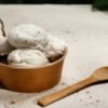 Vegan-And-Non-Dairy-Homemade-Ice-Cream-Using-Coconut-Milk-featured-image-200x620w-half-coconuts-showing-coconut-flesh-with-bowl-of-coconut-milk-and-wooden-spoon-frosted-fusions