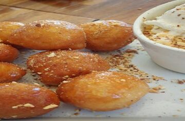 Hot-Meets-Cold-Learn-how-to-Make-Deep-Fried-Ice-Cream-featured-image-200x620w-deep-fried-ice-cream-balls-on-plate-with-dish-of-ice-cream-both-covered-with-sprinkles-frosted-fusions