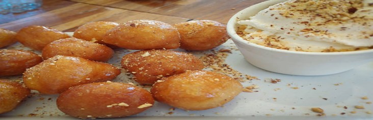 Hot-Meets-Cold-Learn-how-to-Make-Deep-Fried-Ice-Cream-featured-image-200x620w-deep-fried-ice-cream-balls-on-plate-with-dish-of-ice-cream-both-covered-with-sprinkles-frosted-fusions
