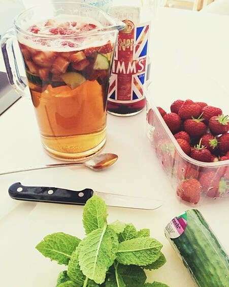 Anyone For Pimms Homemade Pimms And Lemonade Ice Cream image 2 large jug of pimms and lemonade with a punnet of fresh strawberries fresh mint leaves and cucumber frosted fusions