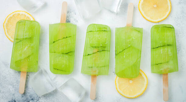 Homemade Gin And Tonic Ice Cream Recipe The Perfect Summer Treat image 3 gin and tonic ice lollies with lemon slices and ice cubes frosted fusions