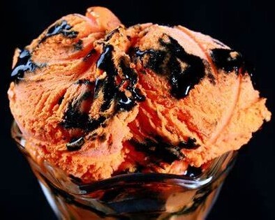Tiger Tail Ice Cream The Sweet And Bold Canadian Classic image 7 glass dish with orange ice cream with swirls of black licorice frosted fusions