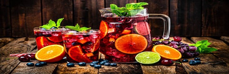 Homemade-Sangria-Ice-Cream-A-Taste-Of-Spain-featured-image-200x620w-jug-and-glasses-filled-with-sangria-and-fresh-fruit-scatter-around-frosted-fusions