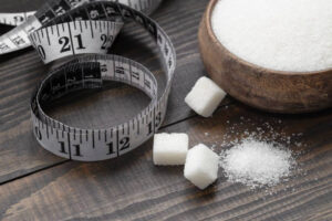 The-Ice-Cream-And-Sugar-Debate-image-1-bowl-filled-with-sugar-with-tape-measure-in-the-background-frosted-fusions