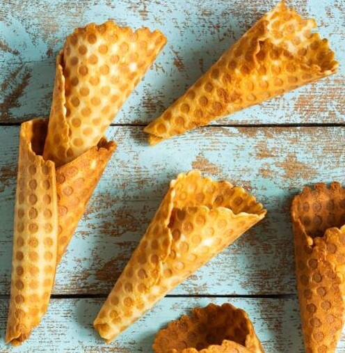 Ice Cream Waffle Cones For Every Diet From Gluten-Sensitive To Dairy Substitutes image 7 several waffle cones on blue wooden background frosted fusions