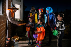 Halloween-Ice-Cream-Treats-Spooky-Ice-Scream-Recipes-For-The-Occasion-image-7-kids-and-adults-in-costumes-trick-and-treating-with-buckets-frosted-fusions