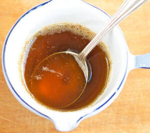 easy-homemade-brown-butter-pecan-ice-cream-image-4-sauce-pan-of-brown-butter-with-silver-spoon-frosted-fusions